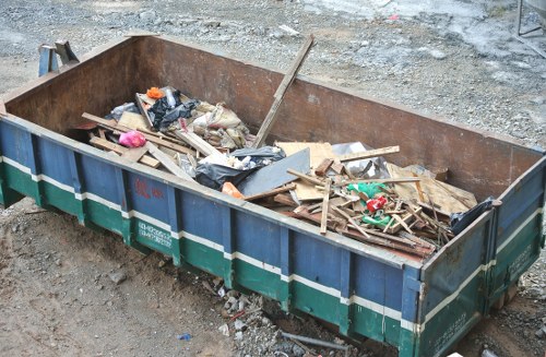 Wanstead Skip Hire branded skip and crew preparing a site