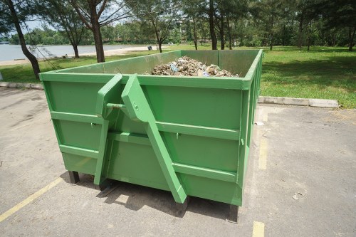 Workers sorting materials at a transfer station and preparing recyclables